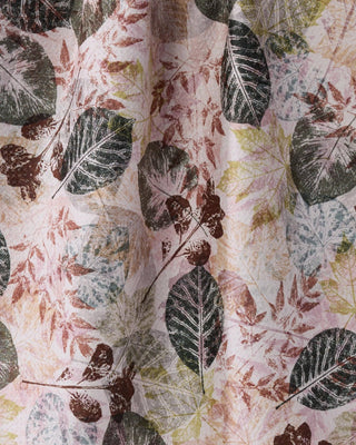 Close-up of Geometry Woodland Press Tea Towel showing Geoweave™ fabric texture with detailed botanical leaf press illustration in dark green, brown, sage, and dusty rose tones on recycled polyester