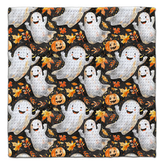 Halloween washcloth featuring smiling ghosts, pumpkins and colorful autumn leaves on a black background