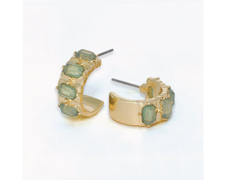 Wide gold huggie hoop earrings with a row of prong-set faceted sage green stones by Periwinkle — bold,
