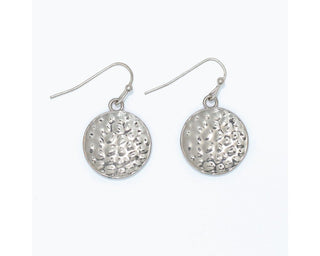 Hammered silver coin disc drop earrings with deeply textured artisan-inspired surface on fishhook wire by Periwinkle — bold yet minimalist silver statement earrings

