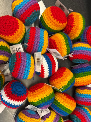 Colorful handcrafted knit kick sacks with crochet design for active outdoor play, coordination practice, and family fun.