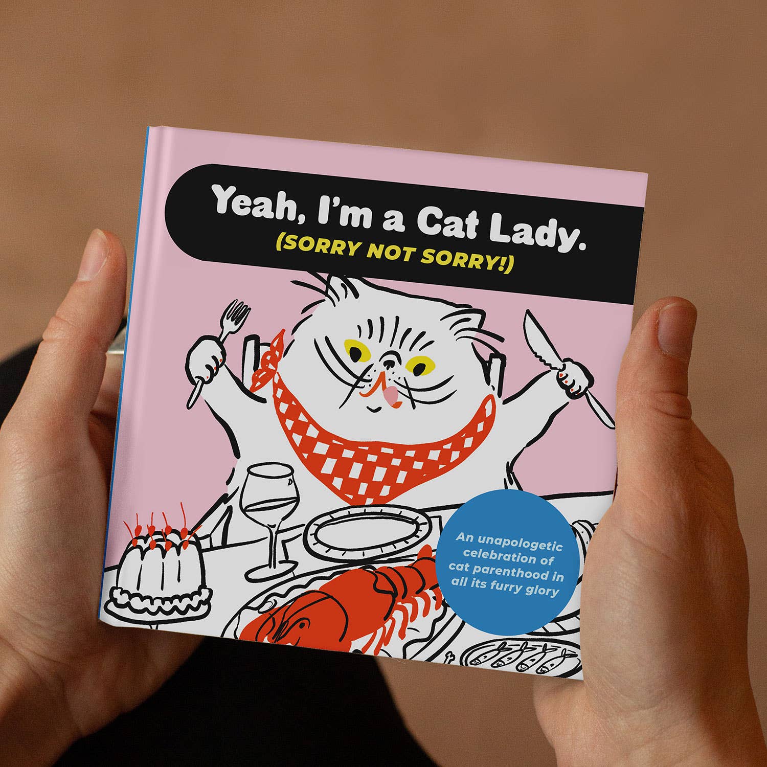 Book titled 'Yeah, I'm a Cat Lady. (Sorry Not Sorry!)' held by a person with a cat illustration on the cover.