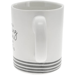 Side of white 15 oz ceramic coffee mug featuring the funny saying "I'm Not a Morning Person But My Cat Is" with gray paw print accents.