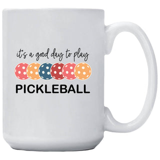 15 oz white ceramic mug featuring the phrase "It's a Good Day to Play Pickleball" with colorful pickleballs and a permanent double-sided design.