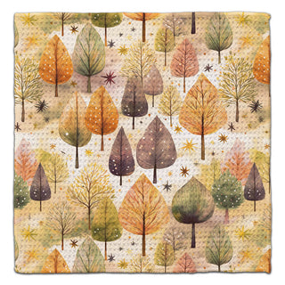 Eco-friendly washcloth featuring a repeating autumn forest pattern with trees in orange, yellow, green, and brown on a warm beige background.