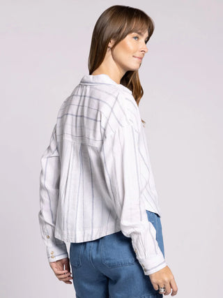 woman wearing white and blue striped cropped linen blend button front shirt back view