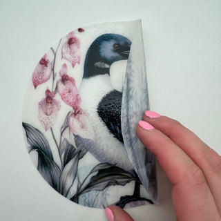 Silicone jar opener featuring Minnesota loon bird and lady slipper flower design