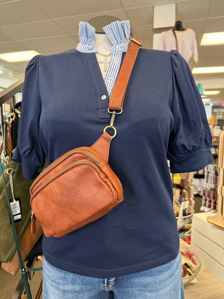 navy puff sleeve top with striped ruffle neckline detail styled with denim shorts