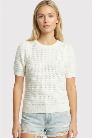woman wearing a white pointelle short puff sleeve lightweight sweater