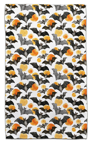 Eco-friendly towel featuring a repeating pattern of bats and polka dots in  black, orange, and gray on a white background.