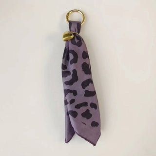 Etta Scarf Bag Charm by Pretty Simple — a vibrant scarf bag charm available in Purple Leopard.
