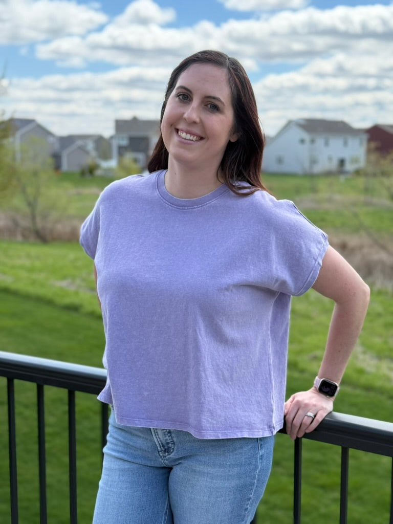 Woman wearing purple mineral wash capped sleeve relaxed fit cotton t-shirt