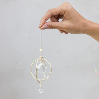 Scout Curated Wears Lotus Strength mini crystal suncatcher featuring gold-plated brass design and crystal prisms creating rainbow reflections