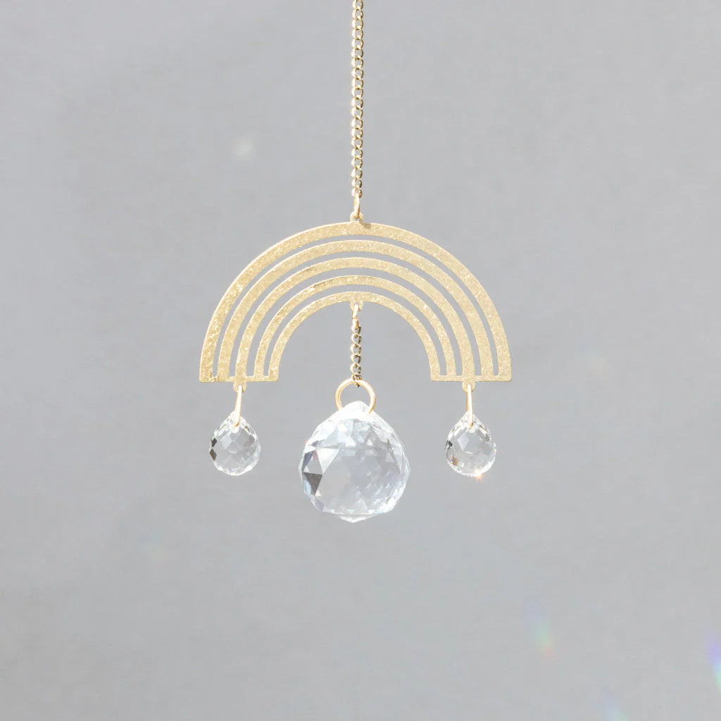 Scout Curated Wears Rainbow Joy mini crystal suncatcher featuring gold rainbow design with hanging crystal prisms and rainbow reflections