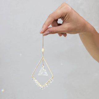Scout Curated Wears Sun Harmony mini crystal suncatcher featuring gold-plated brass frame and crystal prism creating rainbow reflections