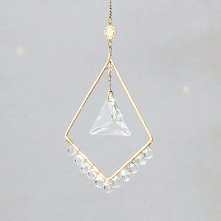 Scout Curated Wears Sun Harmony mini crystal suncatcher featuring gold-plated brass frame and crystal prism creating rainbow reflections