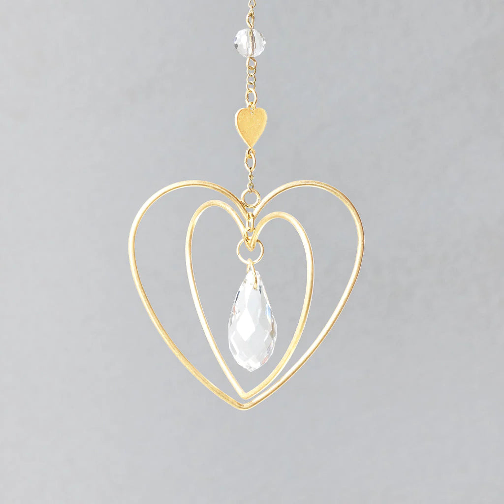Scout Curated Wears heart-shaped crystal mini suncatcher with gold-plated brass design and rainbow-making crystal prism up close view