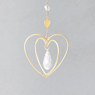 Scout Curated Wears heart-shaped crystal mini suncatcher with gold-plated brass design and rainbow-making crystal prism up close view