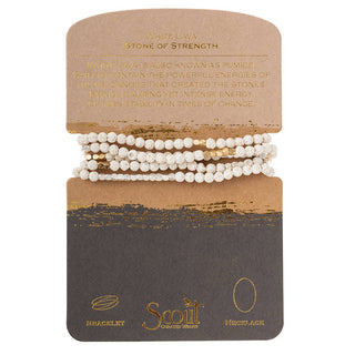 Scout Curated Wears White Lava Stone Wrap bracelet necklace featuring natural white lava gemstones with gold accents and a Stone of Strength meaning card.