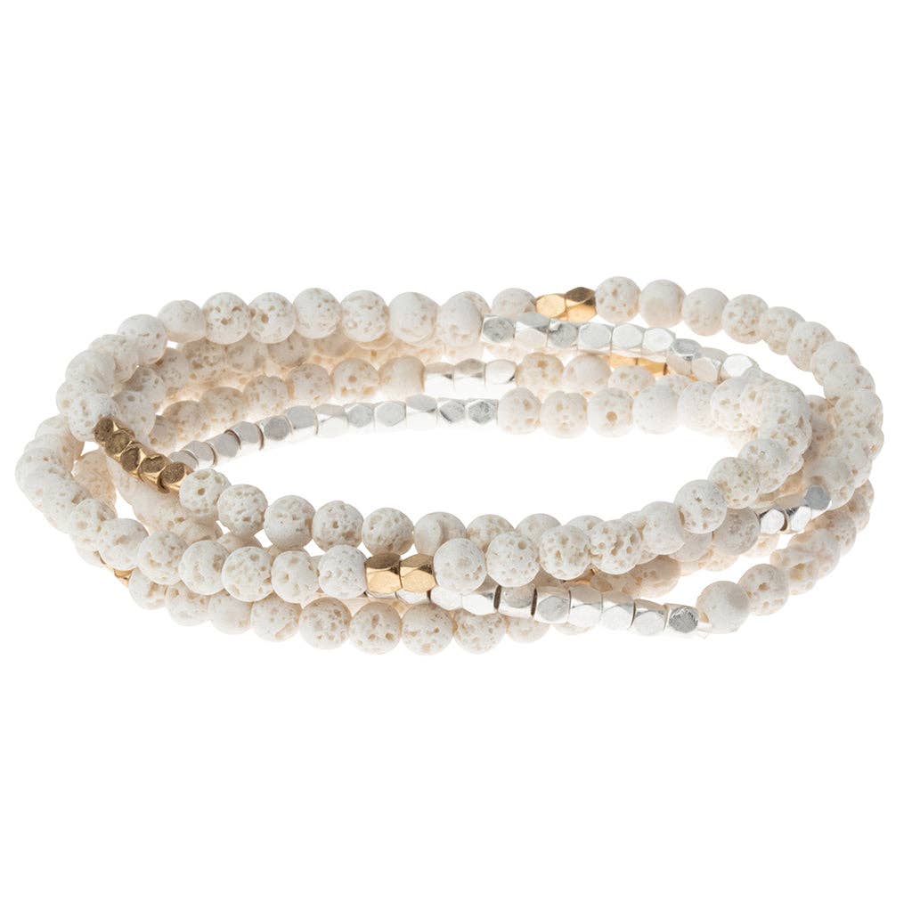 White beaded bracelet with gold accents on a white background