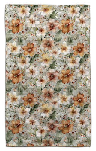 Floral patterned eco-friendly towel with orange and beige flowers on a green background