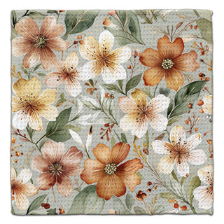 Floral patterned eco-friendly washcloth with brown, yellow, and green flowers on a sage green background