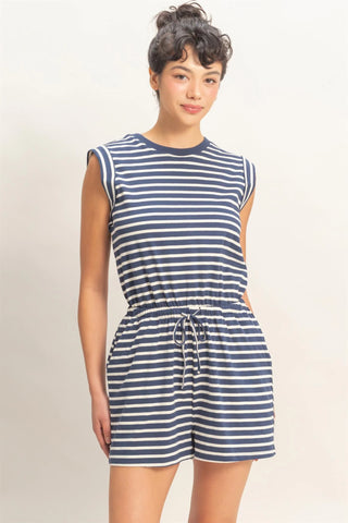 woman wearing navy striped sleeveless romper with drawstring waist and pockets