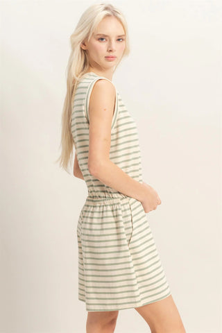 woman wearing sage striped sleeveless romper with drawstring waist and pockets