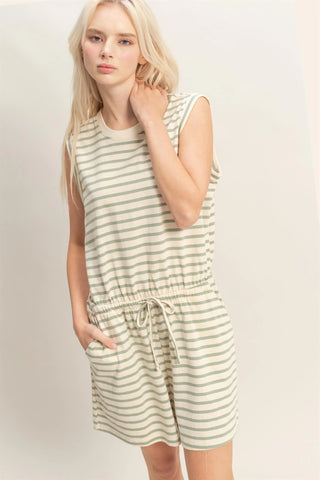 woman wearing sage striped sleeveless romper with drawstring waist and pockets