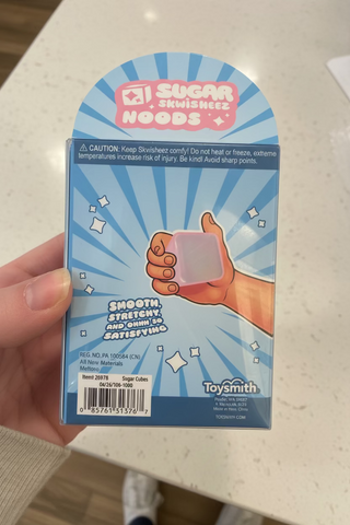 Back of packaging of squishy sugar cube sensory toy for stress relief