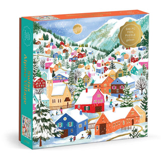 Swiss Alpine Village 500-piece gold foil puzzle by Joanna Clay — snow-covered Alpine village with skiers, evergreen trees, and mountains, 20x20 inches, published by Chronicle Books
