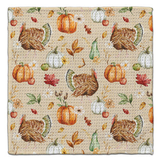 Eco-friendly washcloth featuring a festive autumn pattern with turkeys, pumpkins, gourds, and leaves on a beige background.