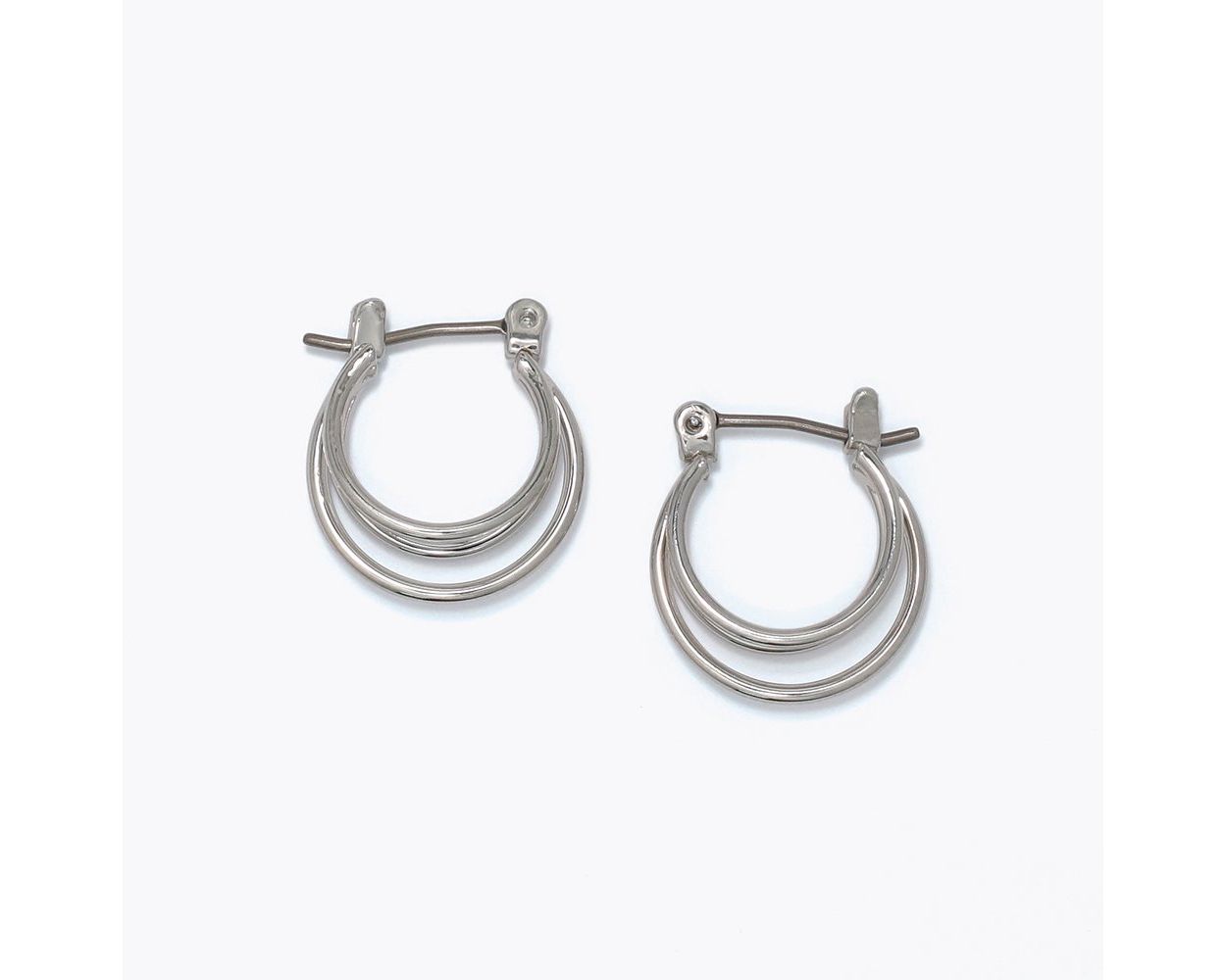 Delicate triple-ring polished silver huggie hoop earrings with latch-back closure by Periwinkle — small minimalist silver hoops perfect for everyday wear and stacking
