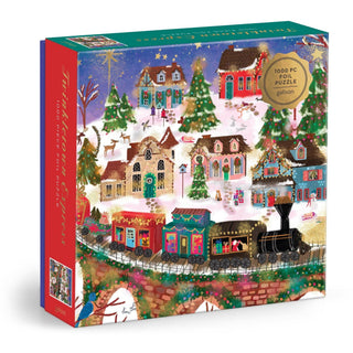 Joy Laforme Twinkletown Express 1000-piece foil puzzle — gold foil Christmas village scene with train, stone bridge, festive cottages, and twinkling trees, 27x20 inches
