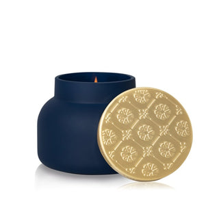 Navy blue Volcano signature candle with a gold lid on a white background