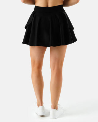 Women’s black tiered flare athletic skort by Waggle with built-in compression shorts