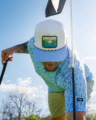 Man wearing Waggle Hill Country snapback hat with western steer and bluebonnet patch