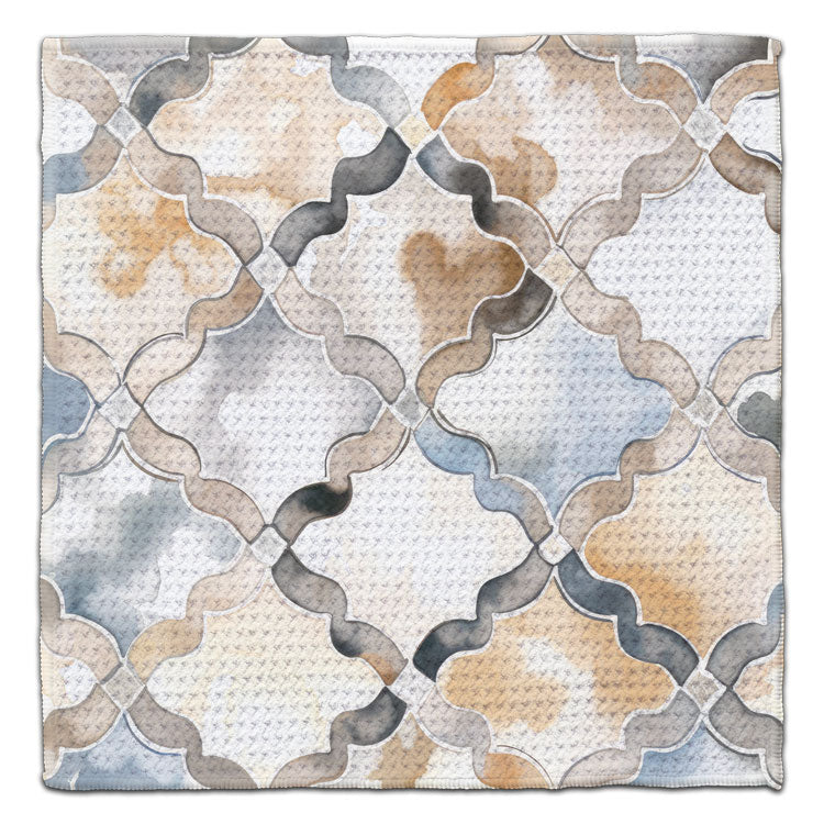 Eco-friendly waffle weave washcloth featuring a watercolor wavy lattice pattern in gray, blue, beige, and cream.