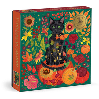 Galison Whiskers of Autumn 500-piece foil puzzle featuring a black cat sitting on pumpkins surrounded by colorful fall flowers, leaves, berries, and shimmering gold foil artwork by Dawn Cooper.