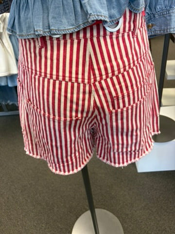 Back of red and white striped shorts with rope tie belt on manequin
