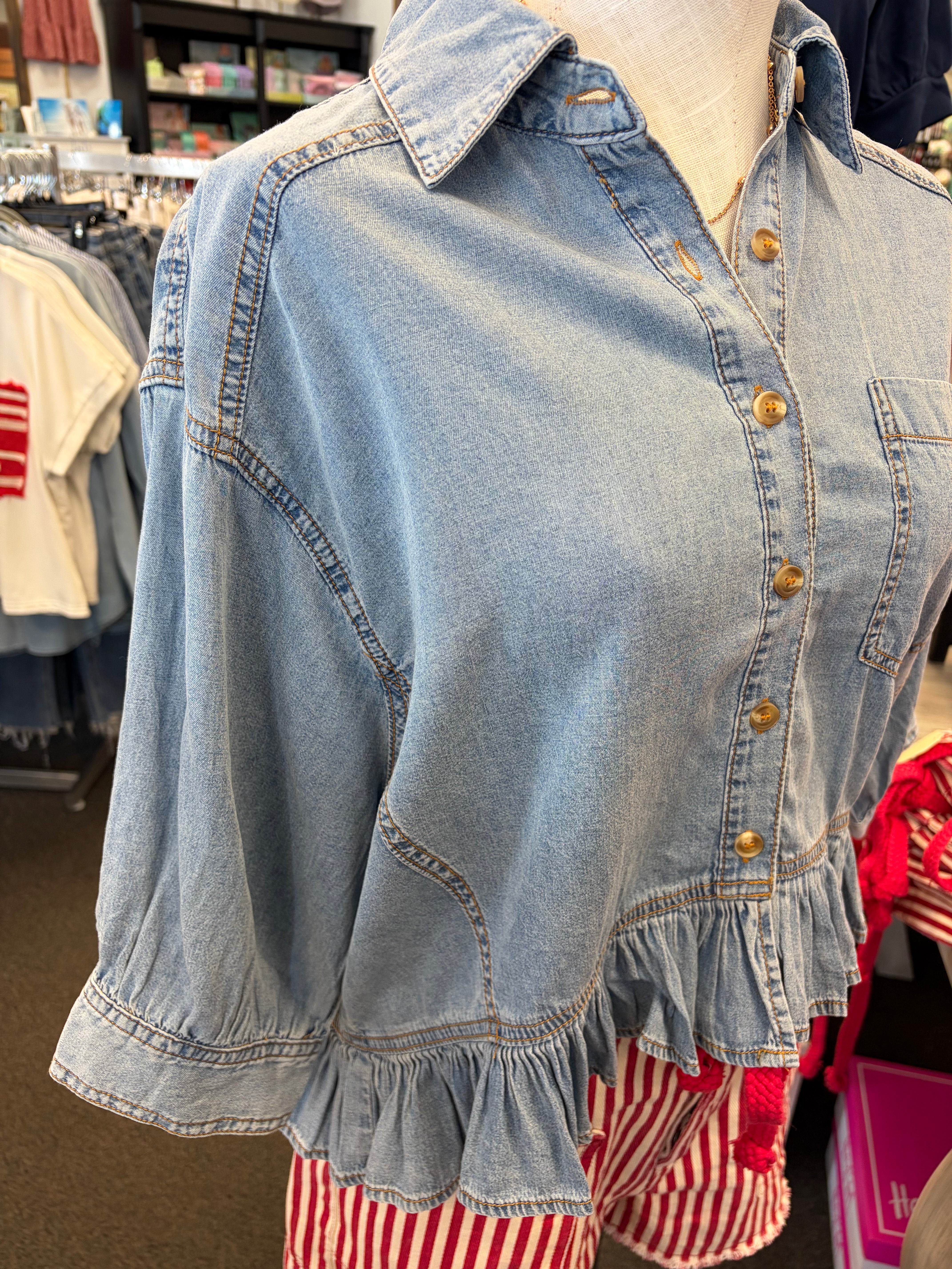 Denim shirt with ruffled hem on a mannequin