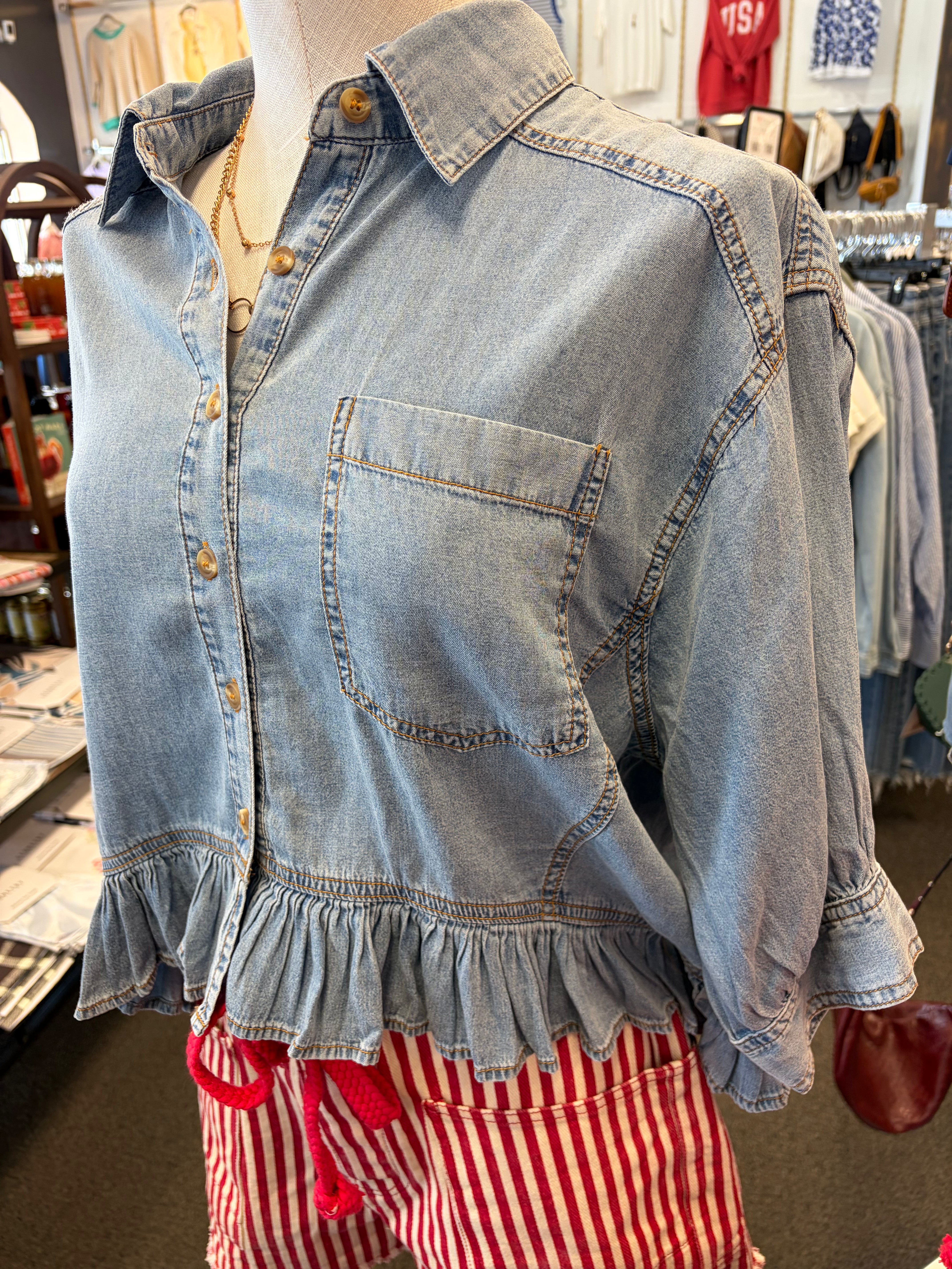 Denim shirt on a mannequin with red and white checkered pants