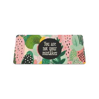 Colorful pouch with tropical leaf design and motivational quote on a white background